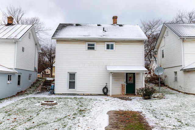 snow covered property featuring an outdoor fire pit