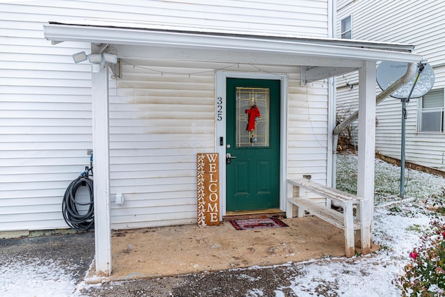 view of snow covered property entrance