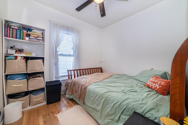 bedroom with hardwood / wood-style floors and ceiling fan