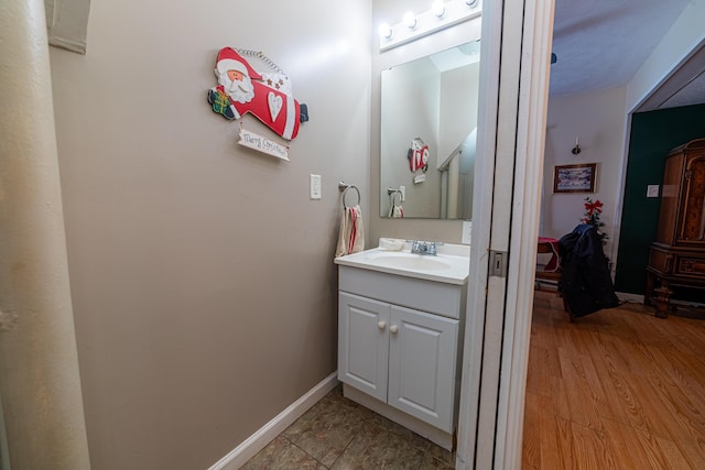 bathroom with vanity and wood-type flooring