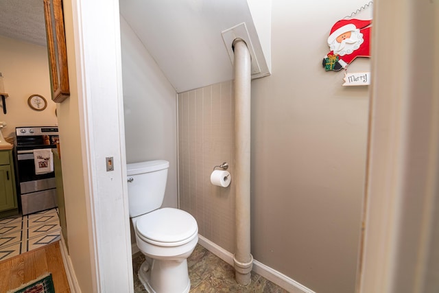 bathroom with baseboards, toilet, and vanity