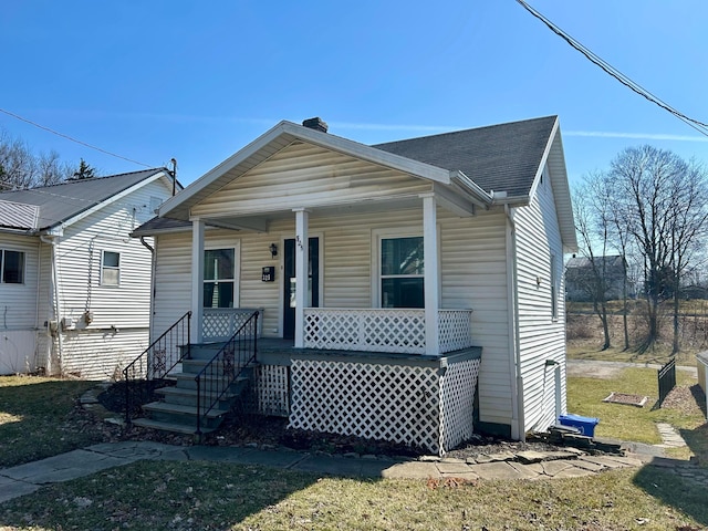 view of front of home with a porch and a shingled roof