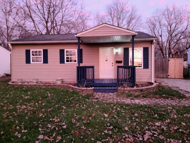 view of front of property with a lawn and a porch