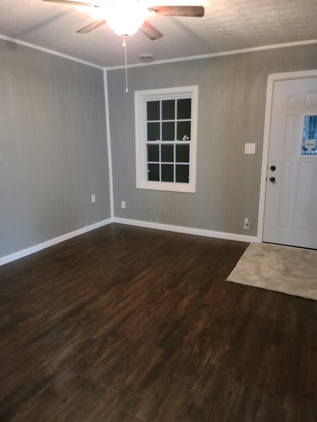 entryway featuring ceiling fan, dark hardwood / wood-style flooring, and ornamental molding