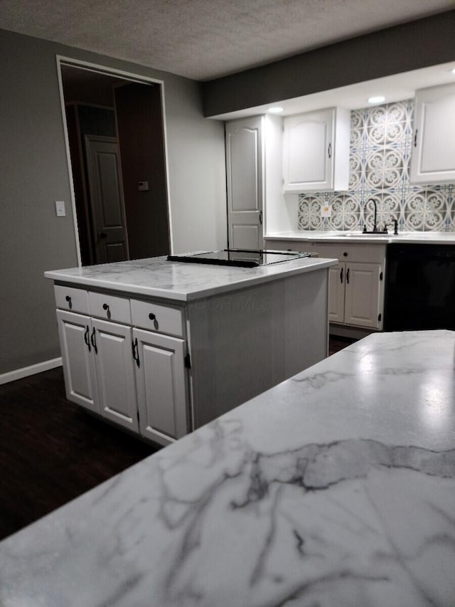 kitchen with a textured ceiling, white cabinetry, dark wood-type flooring, and sink