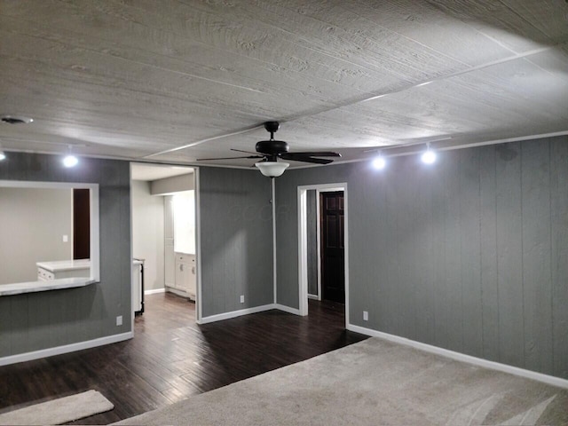 empty room with ceiling fan and dark hardwood / wood-style flooring