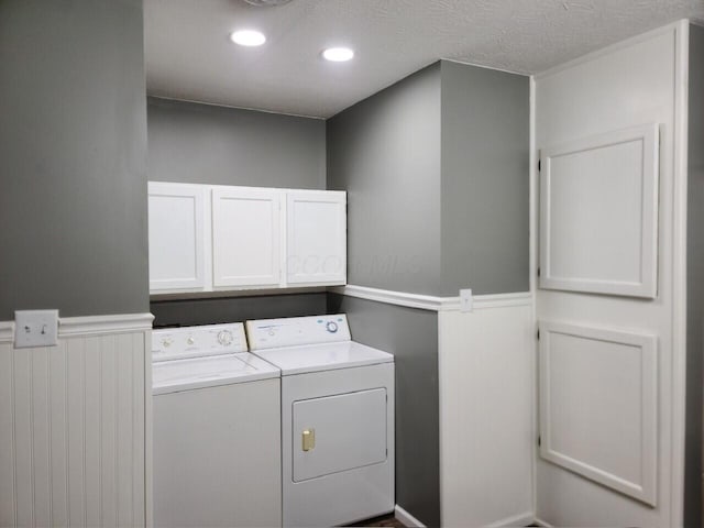 laundry area with washer and clothes dryer and cabinets