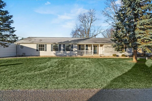 rear view of house with a lawn and covered porch