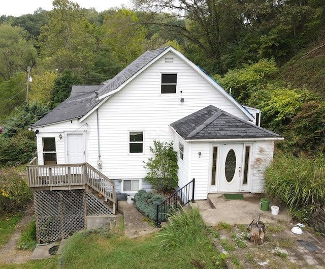 back of property featuring a wooden deck