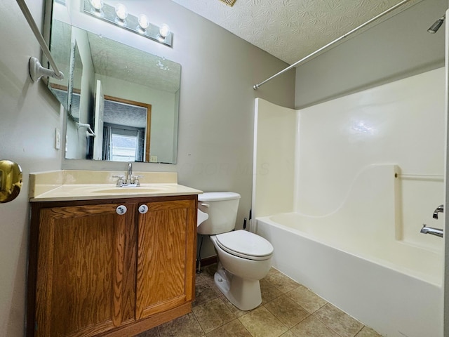 bathroom featuring a textured ceiling, bathtub / shower combination, toilet, vanity, and tile patterned floors