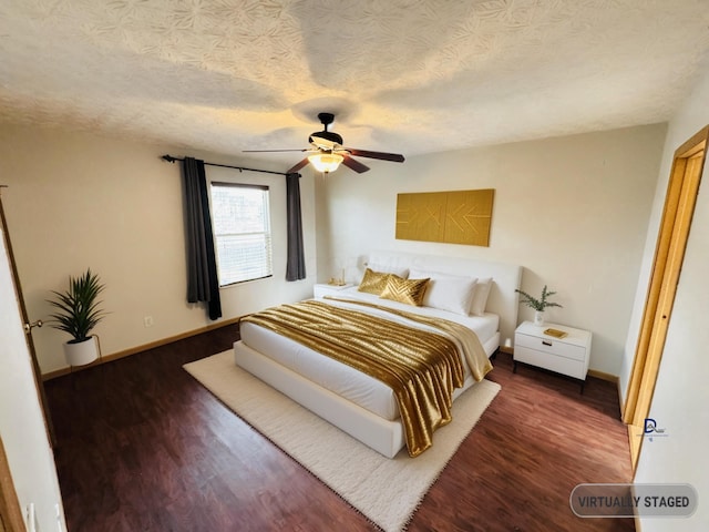 bedroom featuring a textured ceiling, ceiling fan, wood finished floors, and baseboards