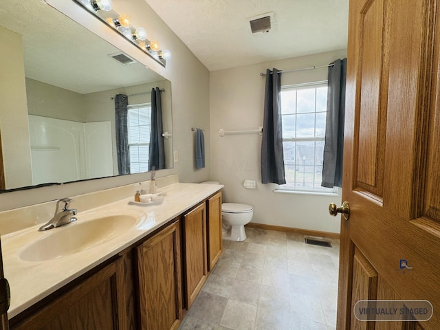 bathroom with baseboards, visible vents, and toilet