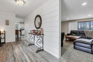 hallway featuring wooden walls and wood-type flooring