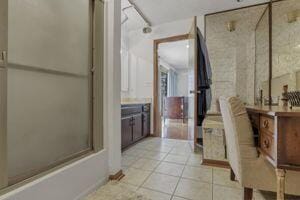 bathroom with tile patterned floors and bath / shower combo with glass door