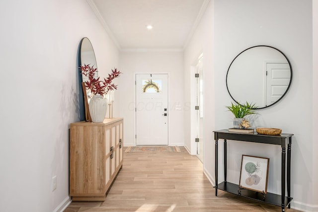 foyer entrance featuring light wood-type flooring and ornamental molding