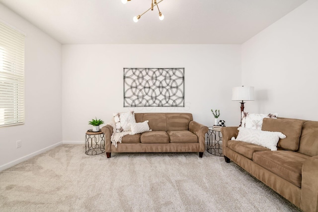 carpeted living room featuring an inviting chandelier and a wealth of natural light