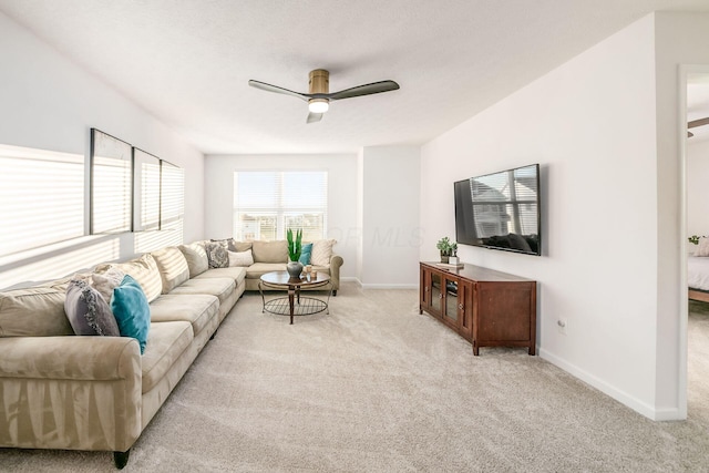 living room featuring ceiling fan and light colored carpet