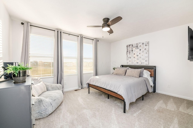 bedroom featuring ceiling fan and light carpet