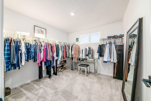 spacious closet with light colored carpet