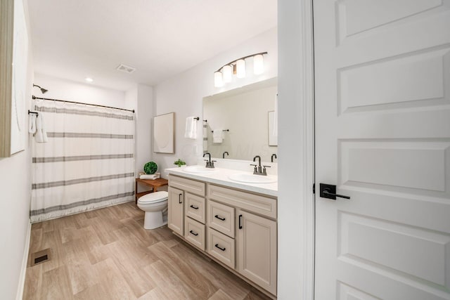 bathroom featuring a shower with curtain, vanity, toilet, and wood-type flooring