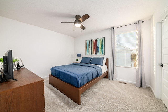 bedroom with ceiling fan and light colored carpet