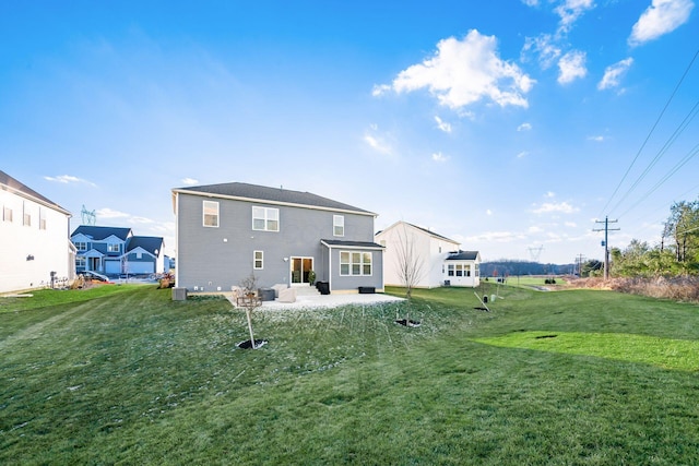 rear view of house featuring a lawn and a patio