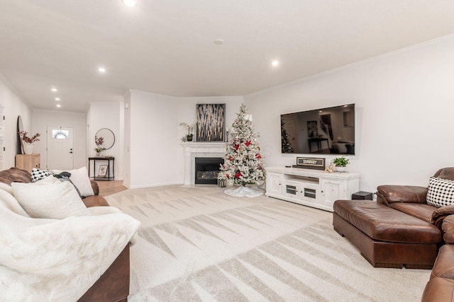 carpeted living room with ornamental molding