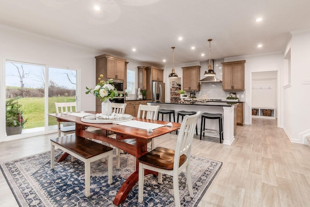 dining room featuring light hardwood / wood-style floors and ornamental molding