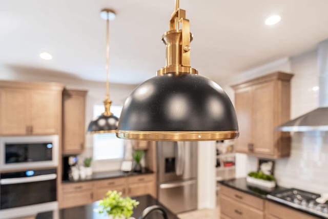 kitchen featuring wall oven, light brown cabinetry, pendant lighting, and cooktop