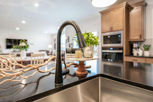 room details with light brown cabinets and white microwave