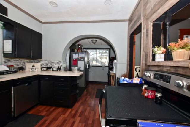 kitchen with backsplash, appliances with stainless steel finishes, crown molding, and dark hardwood / wood-style floors