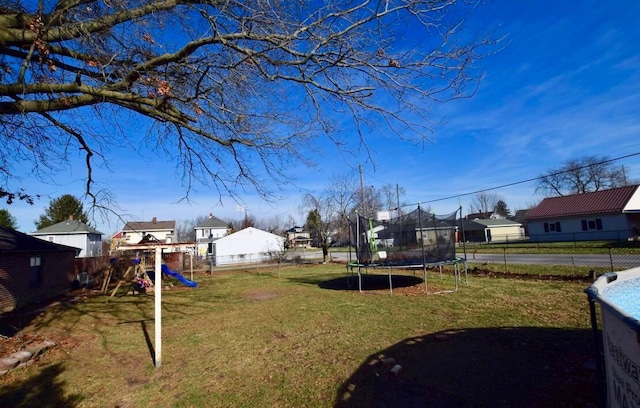 view of yard featuring a playground and a trampoline