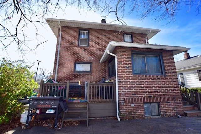 back of property featuring a wooden deck