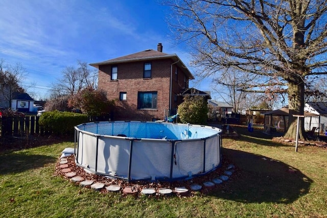 rear view of property with a gazebo and a yard