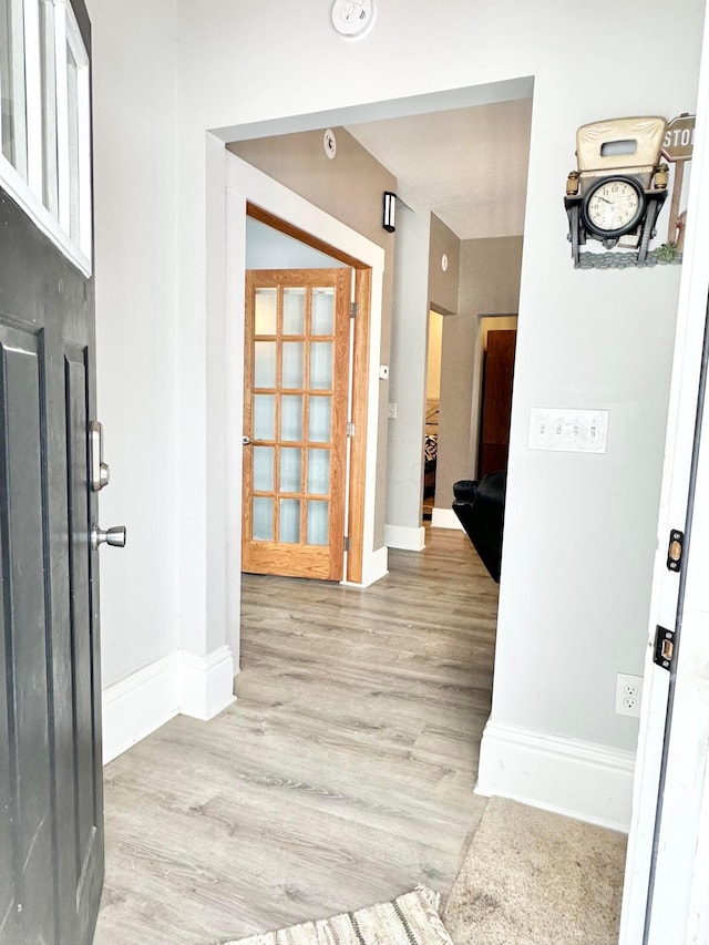 hall with light hardwood / wood-style floors