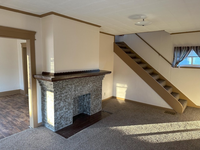 981 Davids St, Marion, OH 43302 - unfurnished living room with carpet, stairs, a fireplace with flush hearth, and crown molding