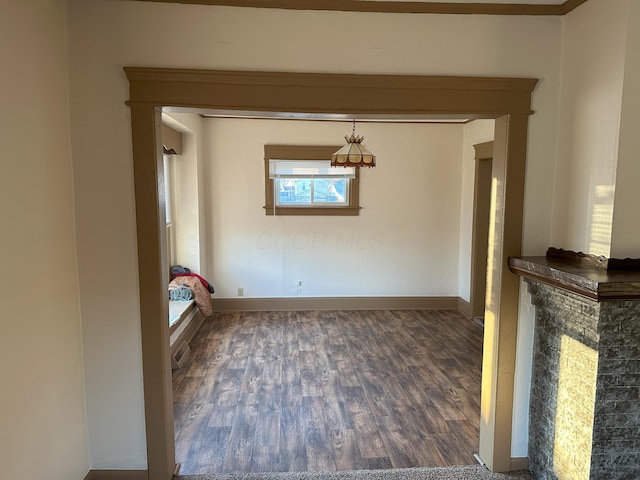 unfurnished dining area featuring dark hardwood / wood-style flooring