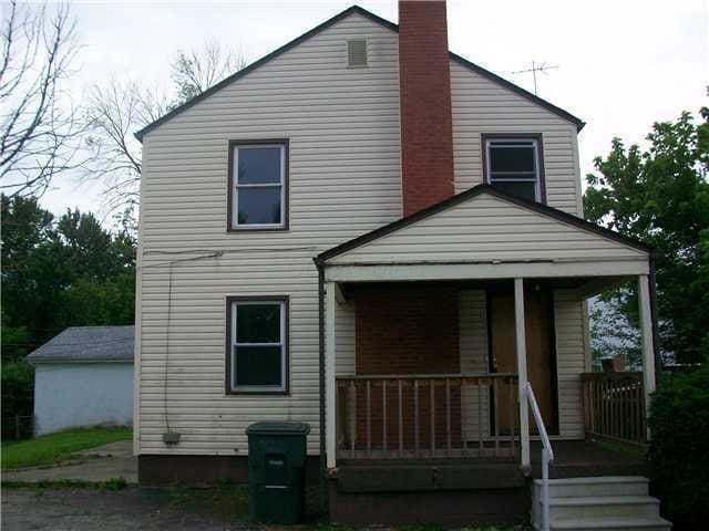 rear view of property with covered porch