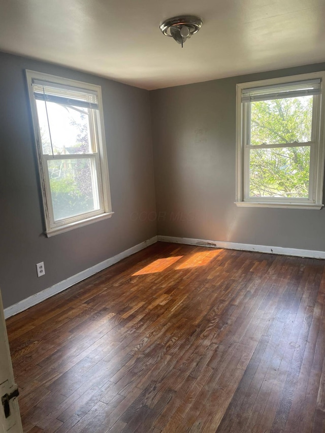 unfurnished room featuring dark hardwood / wood-style flooring