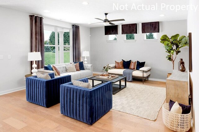 living room with recessed lighting, light wood-type flooring, baseboards, and ceiling fan