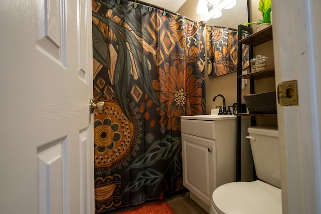 bathroom featuring hardwood / wood-style floors, vanity, and toilet