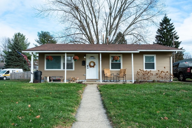 view of front of house with a porch and a front yard