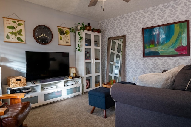 living room featuring carpet flooring, ceiling fan, and a textured ceiling