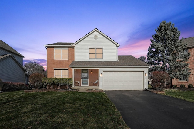 6184 Pirthshire St, Dublin, OH 43016 - traditional-style home with a garage, driveway, roof with shingles, brick siding, and a yard