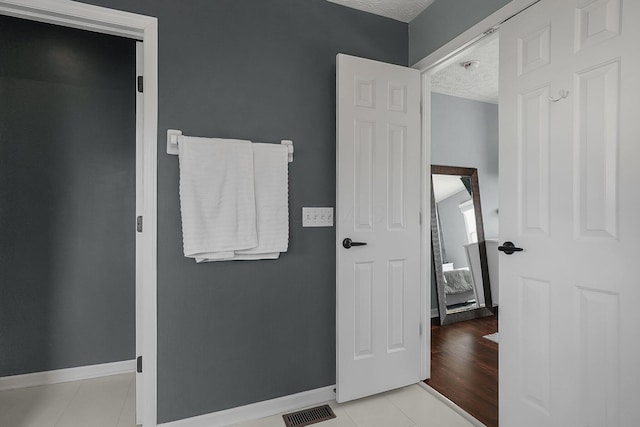 6184 Pirthshire St, Dublin, OH 43016 - bathroom with a textured ceiling, visible vents, baseboards, and tile patterned floors
