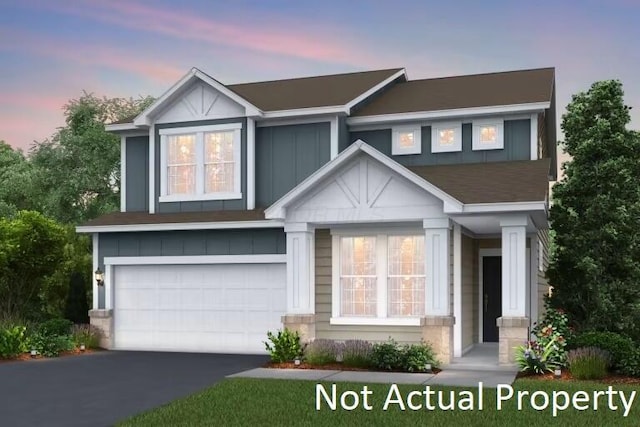 view of front of property with an attached garage, board and batten siding, and driveway