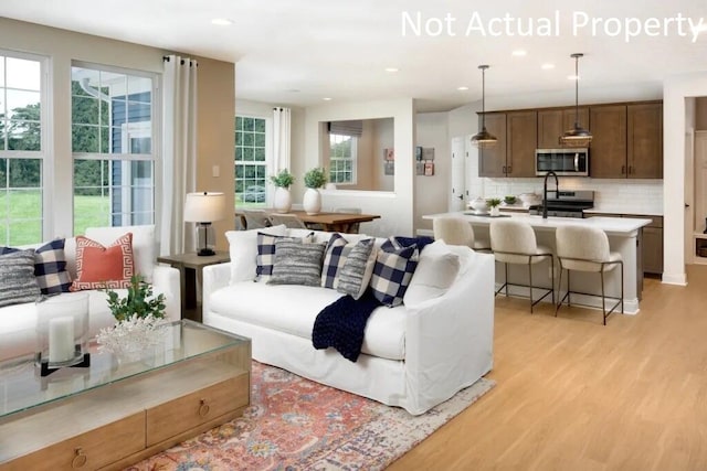 living room with recessed lighting and light wood finished floors