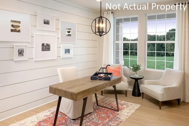 interior space with an inviting chandelier, wood finished floors, and wood walls