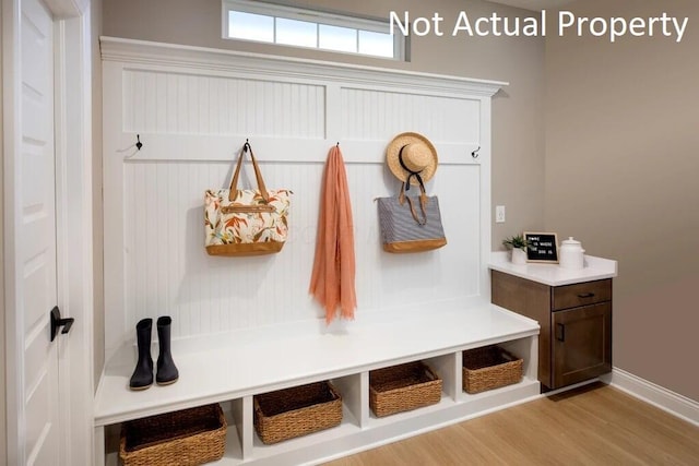 mudroom with baseboards and light wood-style flooring