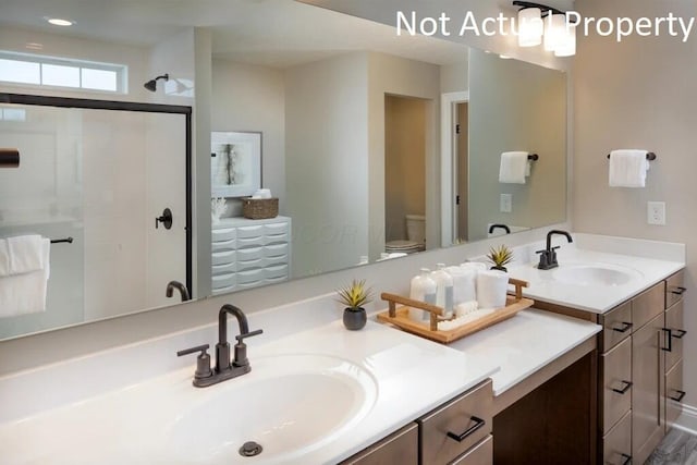 full bath featuring vanity, toilet, and a stall shower